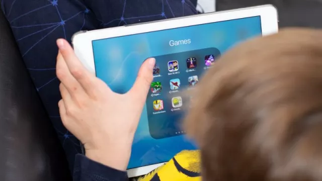 Chlapec si prohlíží hry na tabletu