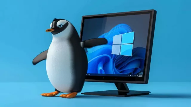 Tučňák před monitorem s logem Windows